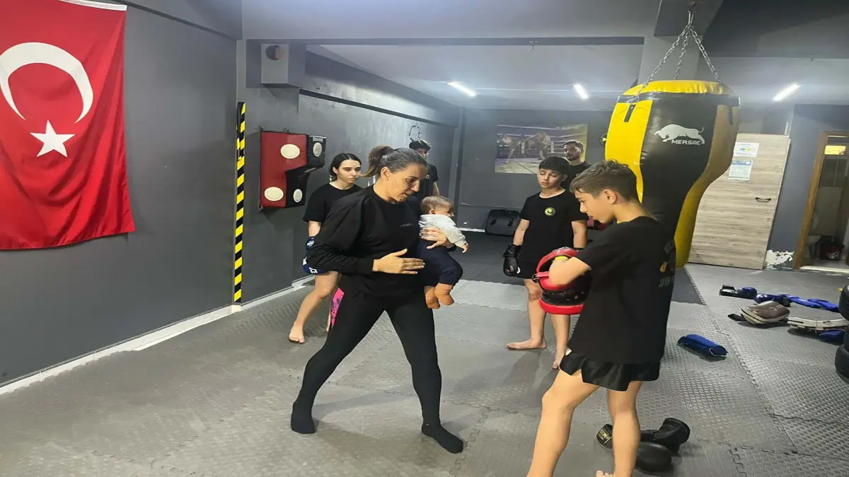 Dünya şampiyonu kick boks antrenörü, ders verdiği salonda çocuklarını büyütüyor